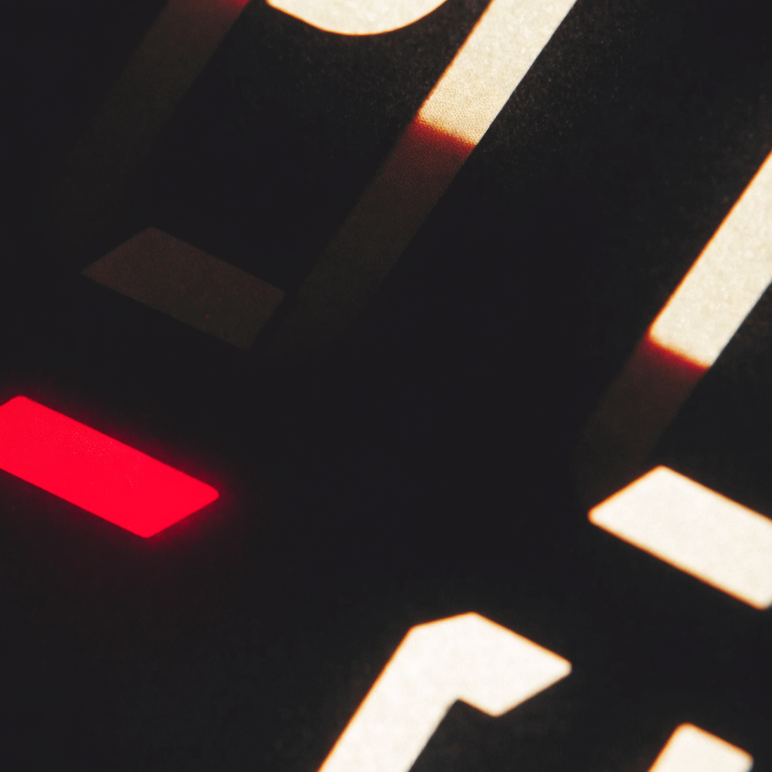 Fragments of a race-clock display, one segment lit crimson